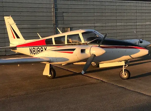 Elite Flight Training Piper Twin Comanche parked at the airport by our flight school