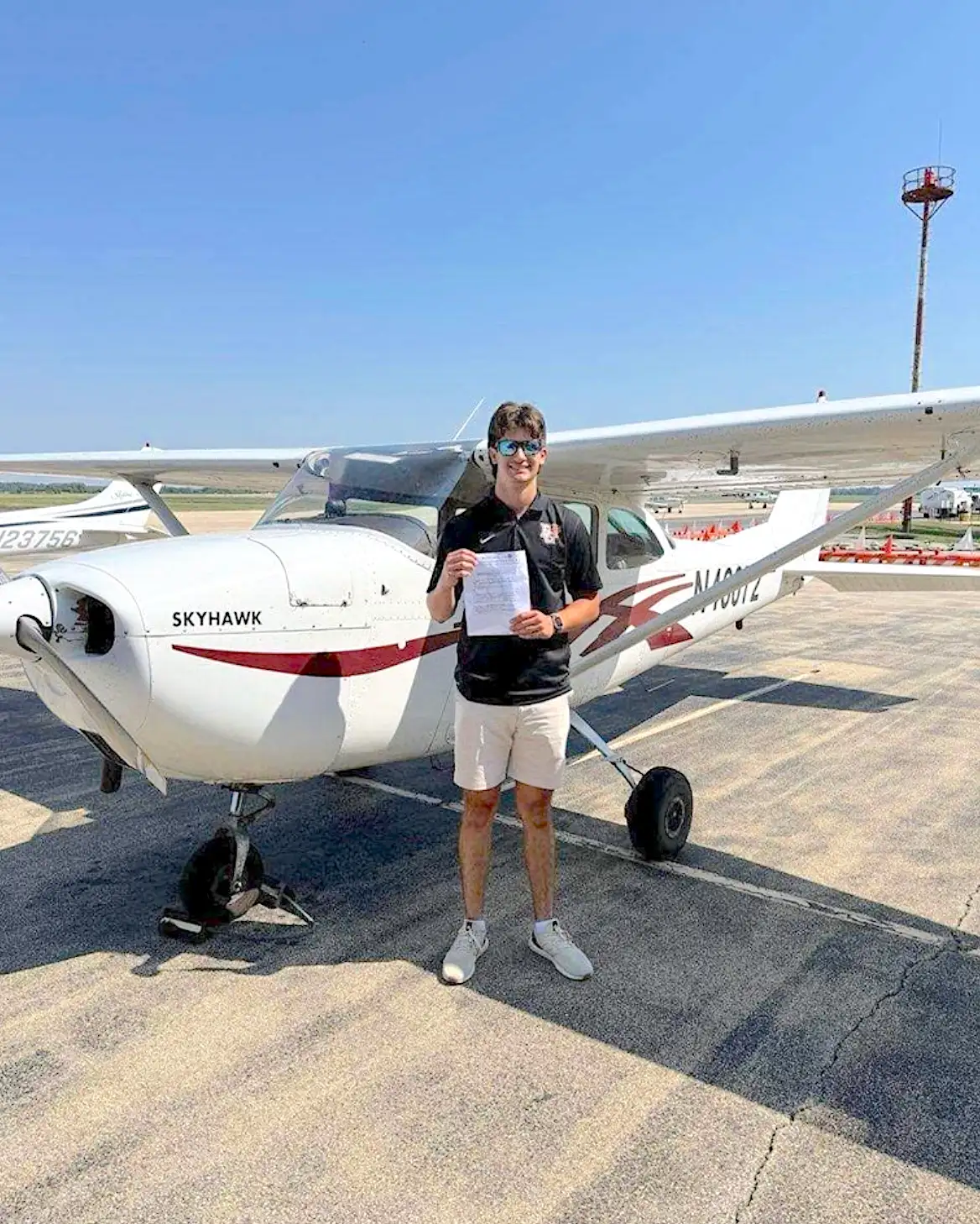 Elite Flight Training student next to a plane after passing a checkride